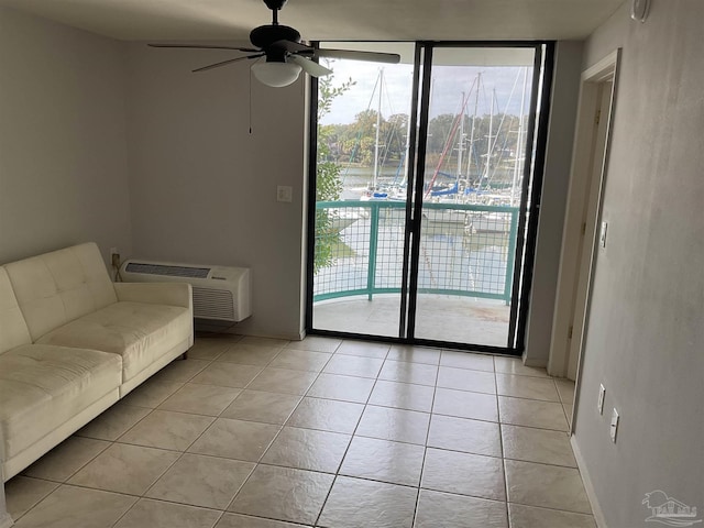 unfurnished living room featuring light tile patterned flooring, ceiling fan, and an AC wall unit