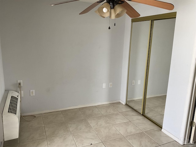 unfurnished bedroom featuring light tile patterned floors, ceiling fan, and a closet