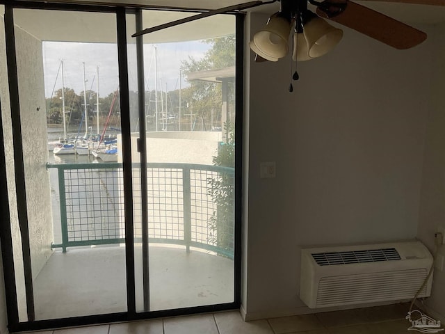 doorway to outside featuring light tile patterned flooring, ceiling fan, expansive windows, and an AC wall unit