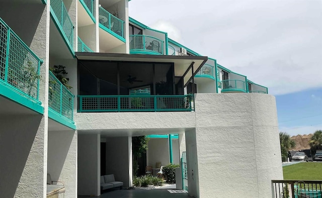 rear view of house featuring ceiling fan