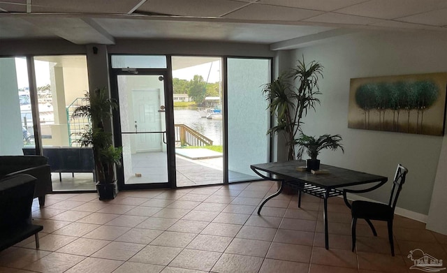 entryway featuring light tile patterned flooring and a water view