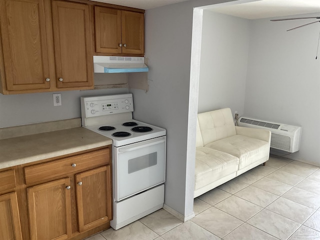 kitchen with ceiling fan, an AC wall unit, light tile patterned floors, and white range with electric stovetop