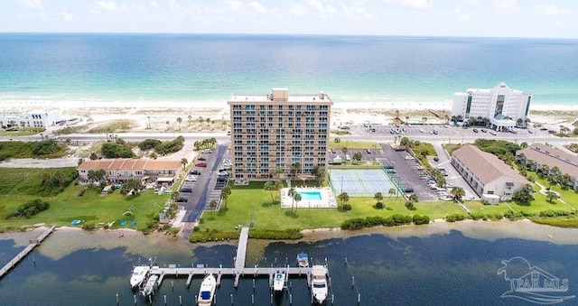 birds eye view of property with a water view and a beach view