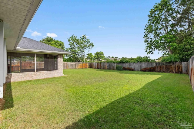 view of yard with a fenced backyard