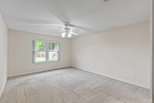 unfurnished room with a textured ceiling, baseboards, ceiling fan, and carpet