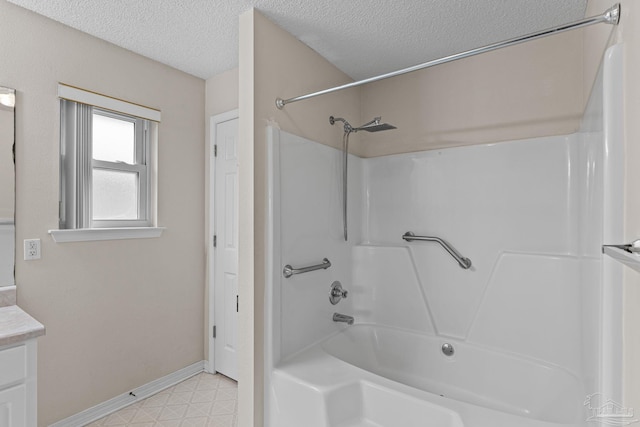 full bathroom featuring vanity, a textured ceiling, tile patterned floors,  shower combination, and baseboards