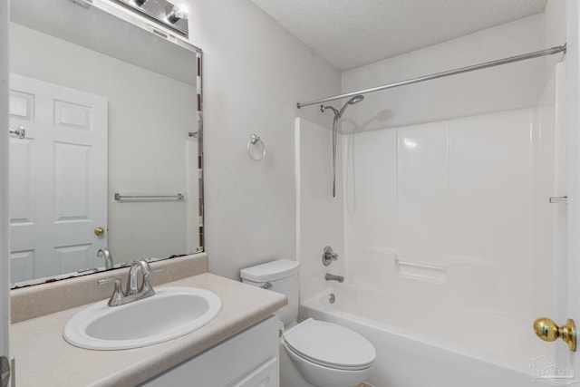 bathroom with toilet, washtub / shower combination, vanity, and a textured ceiling
