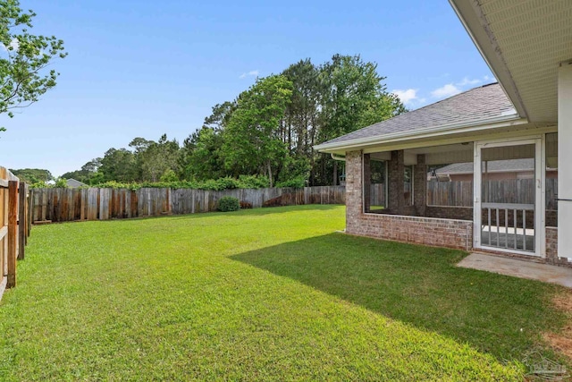 view of yard with a fenced backyard