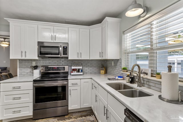 kitchen featuring white cabinetry, appliances with stainless steel finishes, sink, and tasteful backsplash