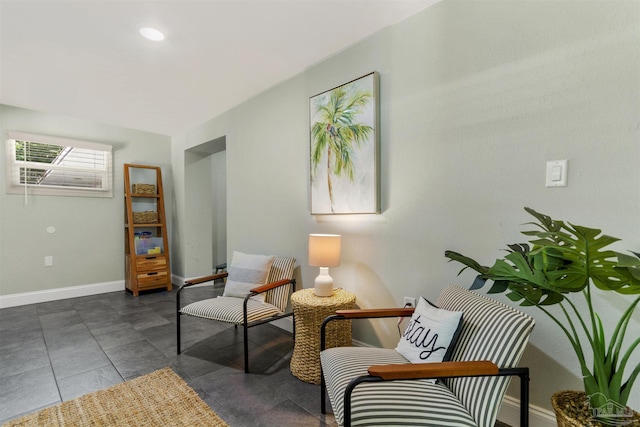 sitting room featuring dark tile patterned flooring