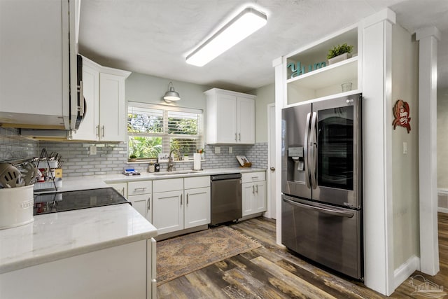 kitchen with sink, white cabinets, stainless steel refrigerator, and dishwasher