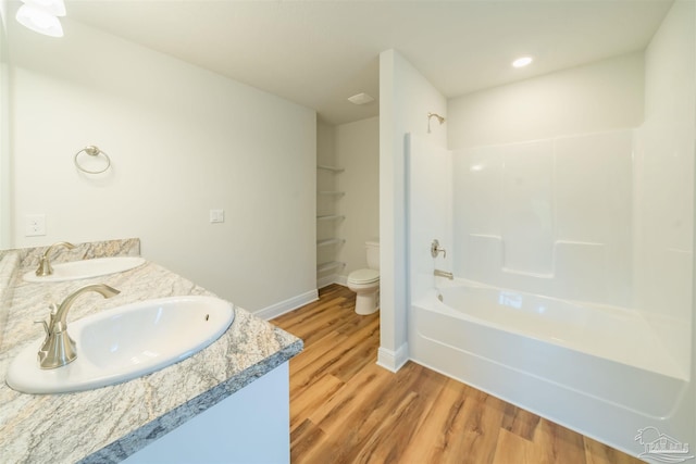 full bathroom with toilet, shower / tub combination, hardwood / wood-style flooring, and double vanity