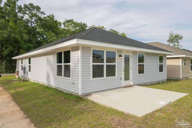 exterior space featuring a front lawn and a patio area