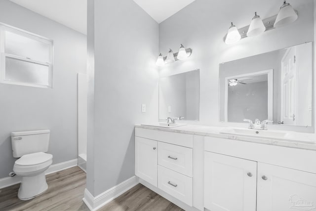 bathroom featuring wood-type flooring, vanity, and toilet