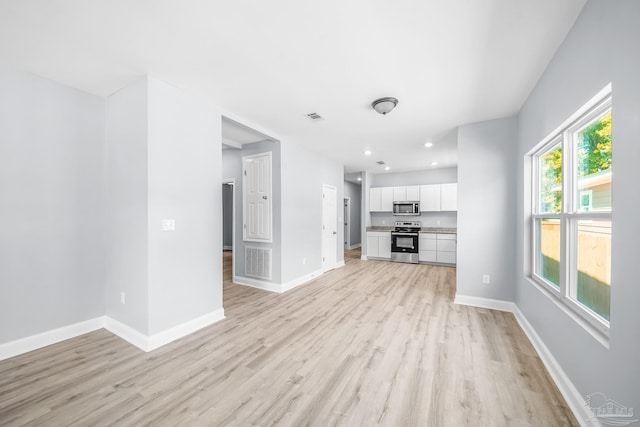 unfurnished living room featuring light wood-type flooring