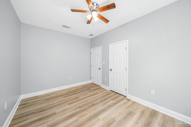 spare room with ceiling fan and light wood-type flooring