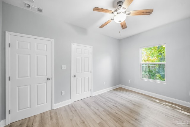 unfurnished room featuring ceiling fan and light wood-type flooring