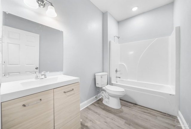 full bathroom featuring vanity, toilet, tub / shower combination, and hardwood / wood-style floors