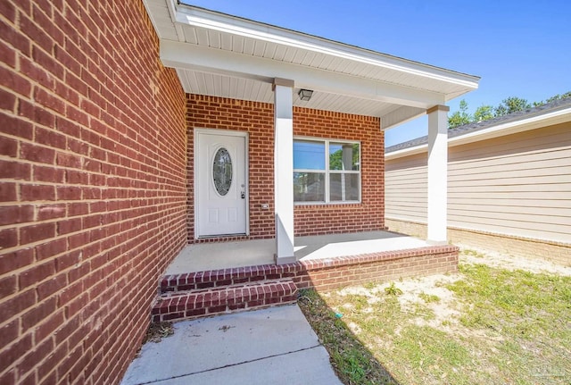 view of exterior entry with covered porch