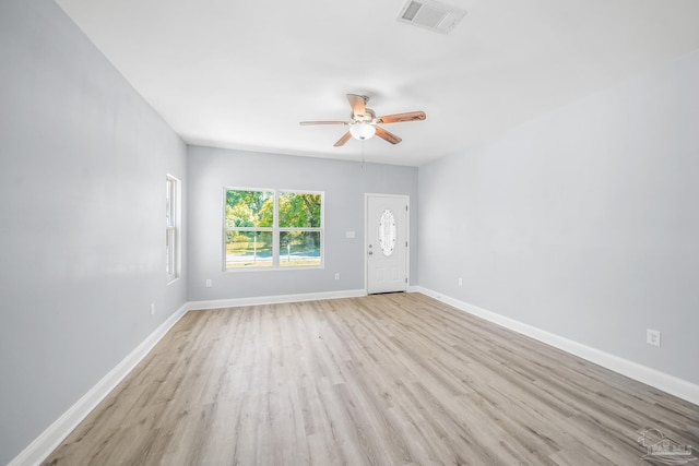 empty room with light hardwood / wood-style floors and ceiling fan