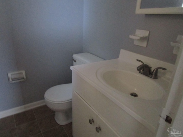 bathroom with toilet, baseboards, tile patterned flooring, and vanity