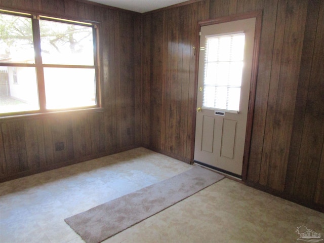 spare room with wood walls