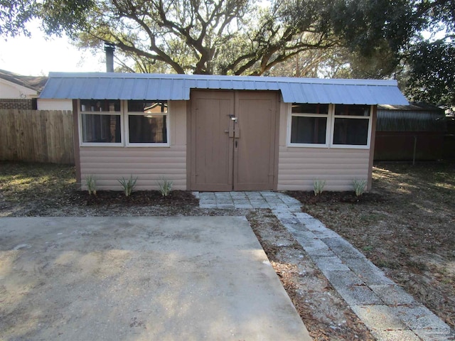 view of outbuilding with an outbuilding and fence