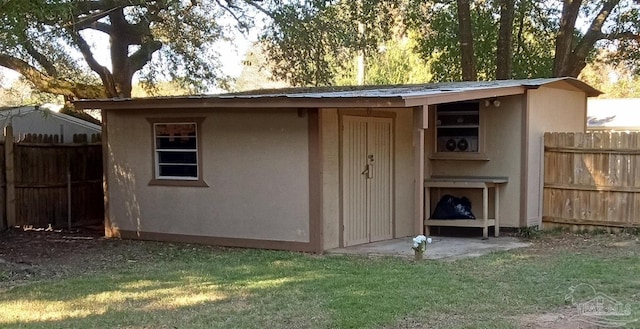 view of outbuilding with fence and an outdoor structure