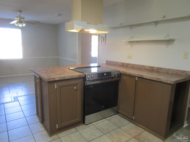 kitchen featuring a peninsula, open shelves, range hood, light tile patterned floors, and stainless steel electric range oven