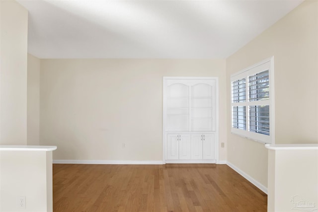 unfurnished room with light wood-type flooring