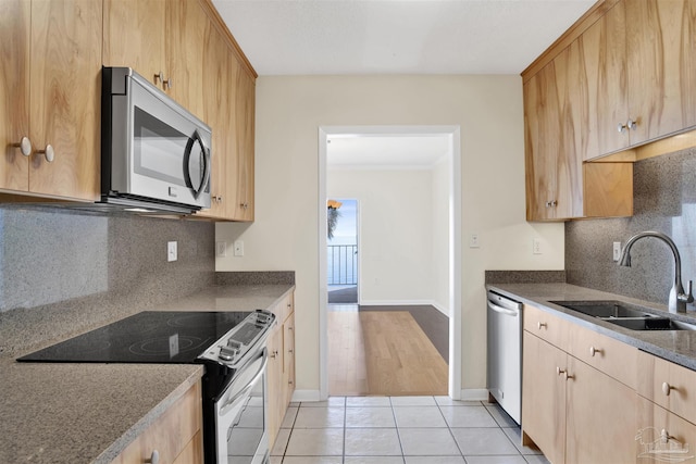 kitchen featuring appliances with stainless steel finishes, sink, backsplash, light tile patterned floors, and light brown cabinets