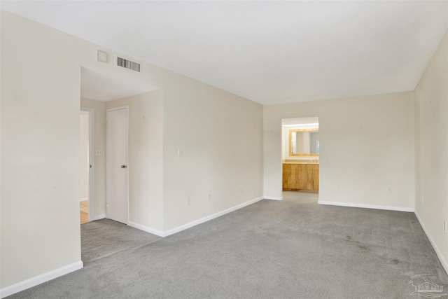 empty room featuring light carpet