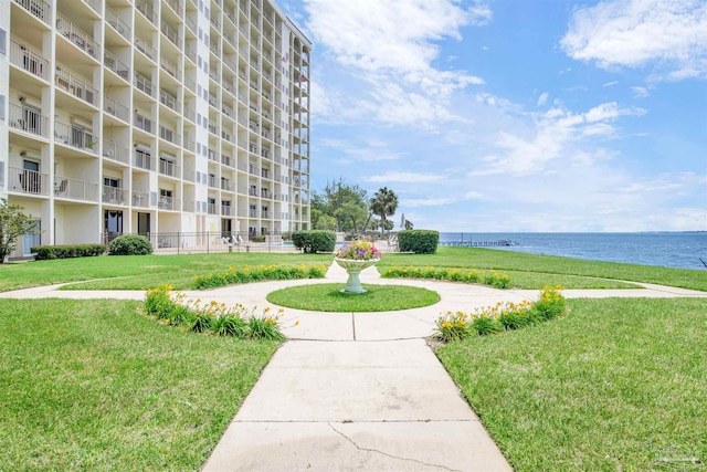 view of home's community featuring a water view and a yard