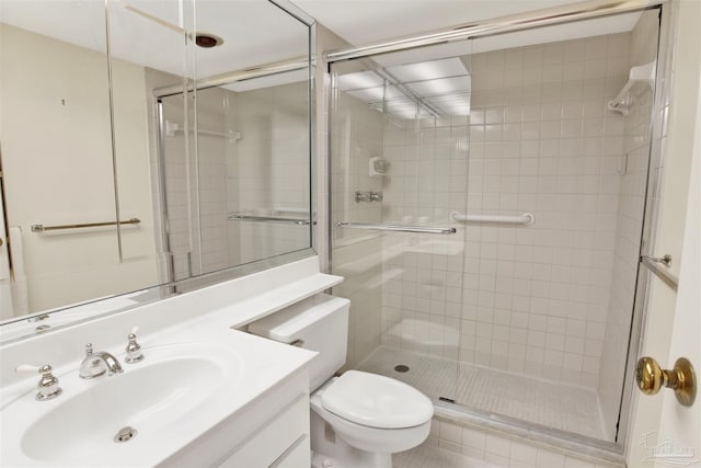 bathroom with vanity, an enclosed shower, and toilet