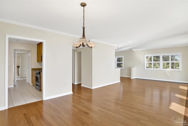 interior space featuring crown molding, light wood-type flooring, and an inviting chandelier