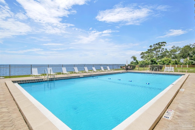 view of pool with a water view