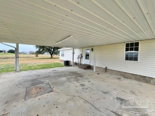 view of patio / terrace with an attached carport and central AC