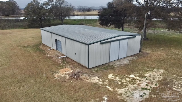 view of outdoor structure featuring an outbuilding and a water view