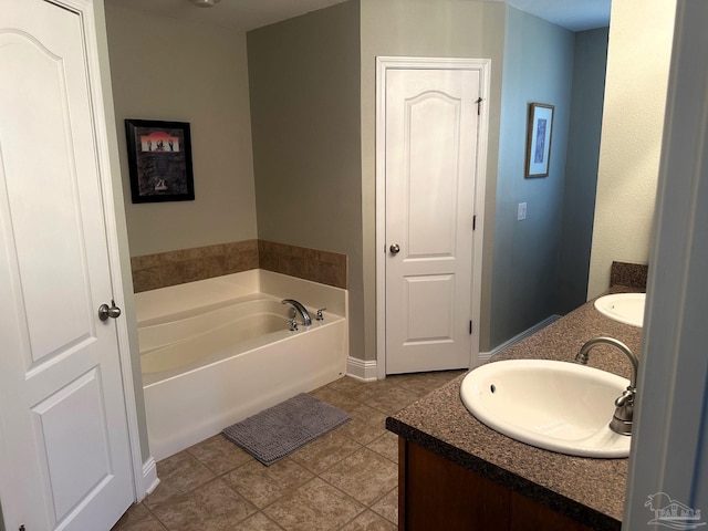 bathroom featuring a bathing tub, tile patterned flooring, and vanity