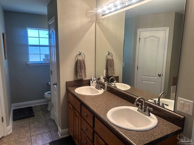 bathroom with tile patterned floors, vanity, and toilet