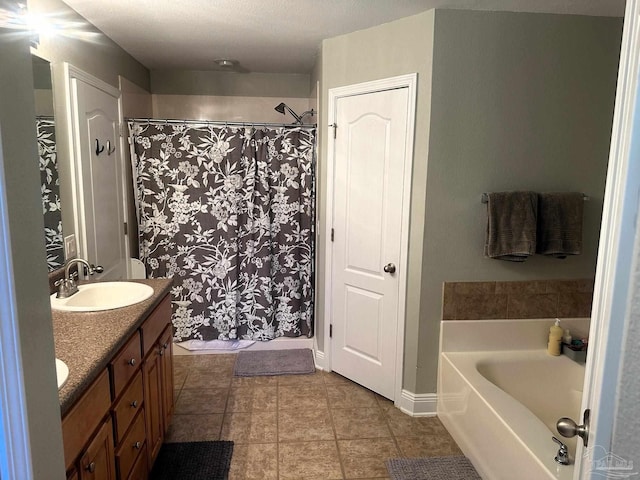 bathroom with a tub to relax in, tile patterned flooring, and vanity