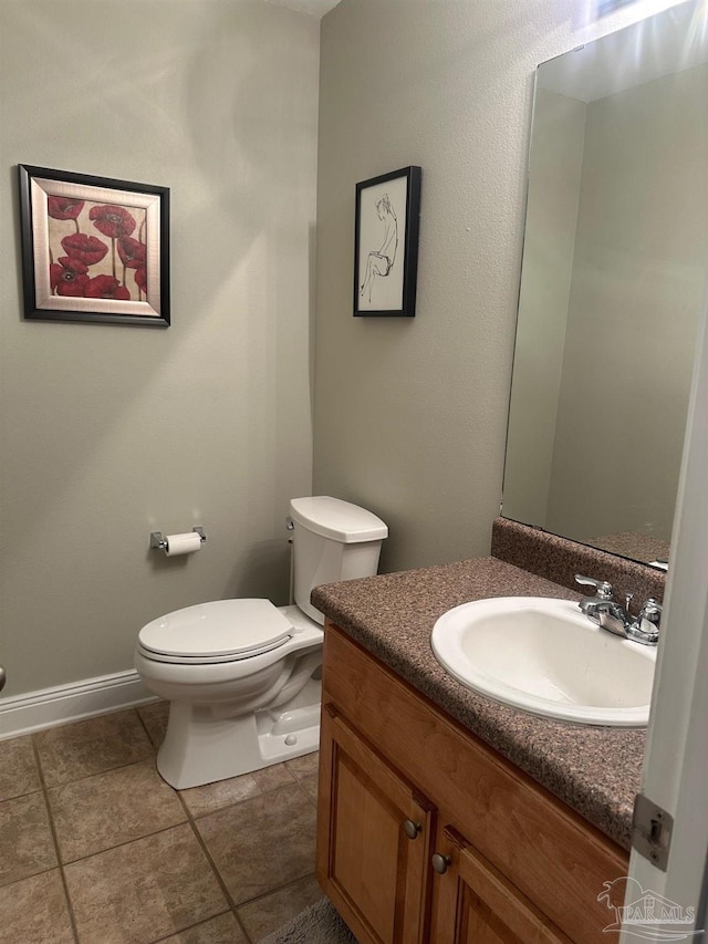 bathroom featuring tile patterned floors, vanity, and toilet