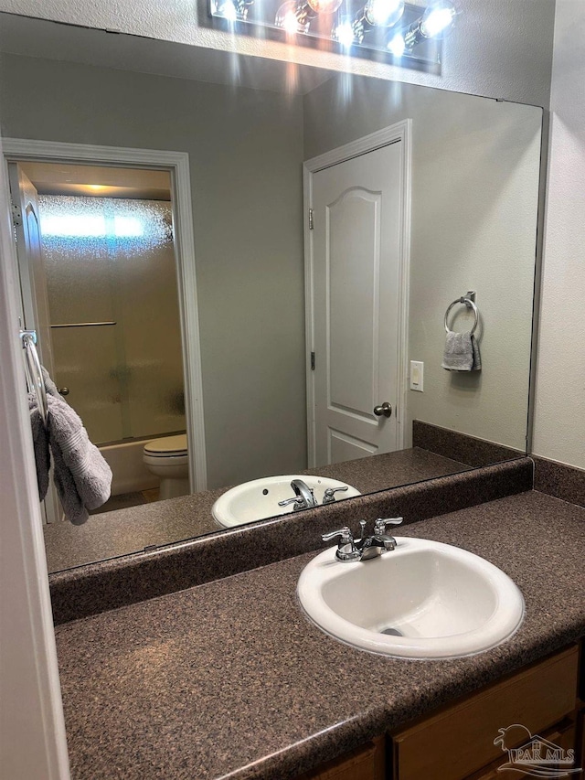 bathroom featuring vanity and shower / bath combination with glass door