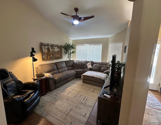 living room featuring a healthy amount of sunlight, light wood-type flooring, ceiling fan, and lofted ceiling