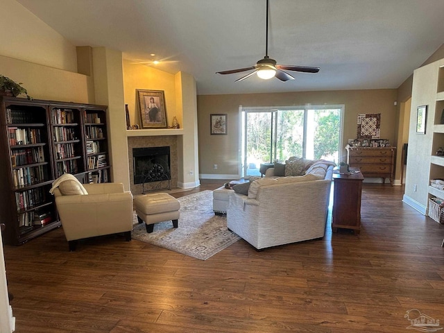 living room featuring ceiling fan, dark wood-type flooring, and vaulted ceiling