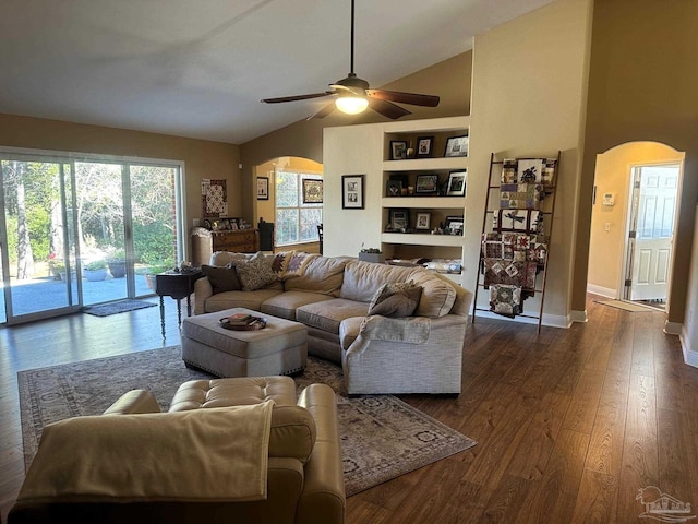 living room with ceiling fan, built in features, dark wood-type flooring, and lofted ceiling