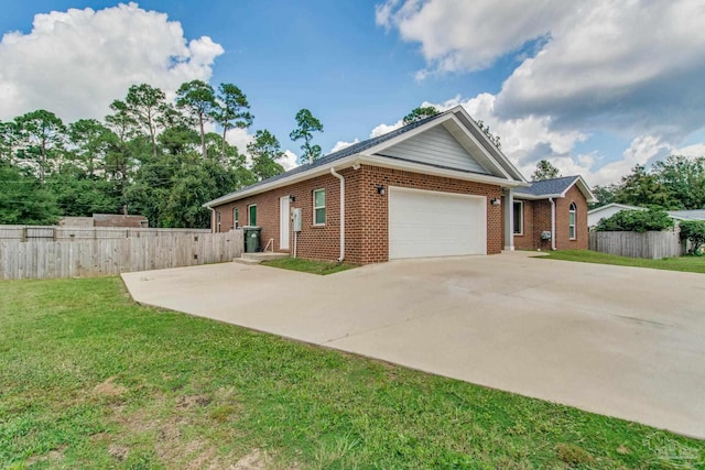 view of front of house with a garage and a front lawn