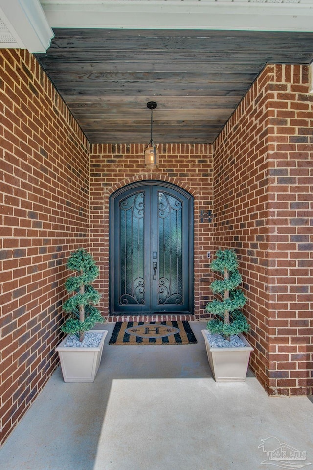 view of exterior entry featuring french doors