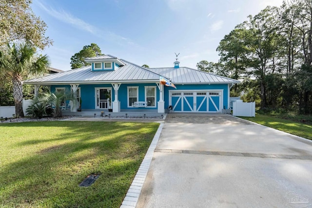 view of front of property with a garage, covered porch, and a front lawn