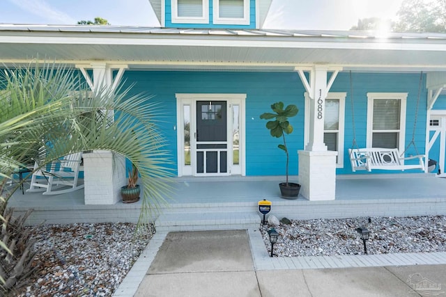 view of exterior entry with a porch